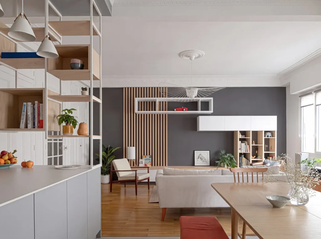 Living room with slatted oak panelling, a white floating media unit and an oak shelving divider