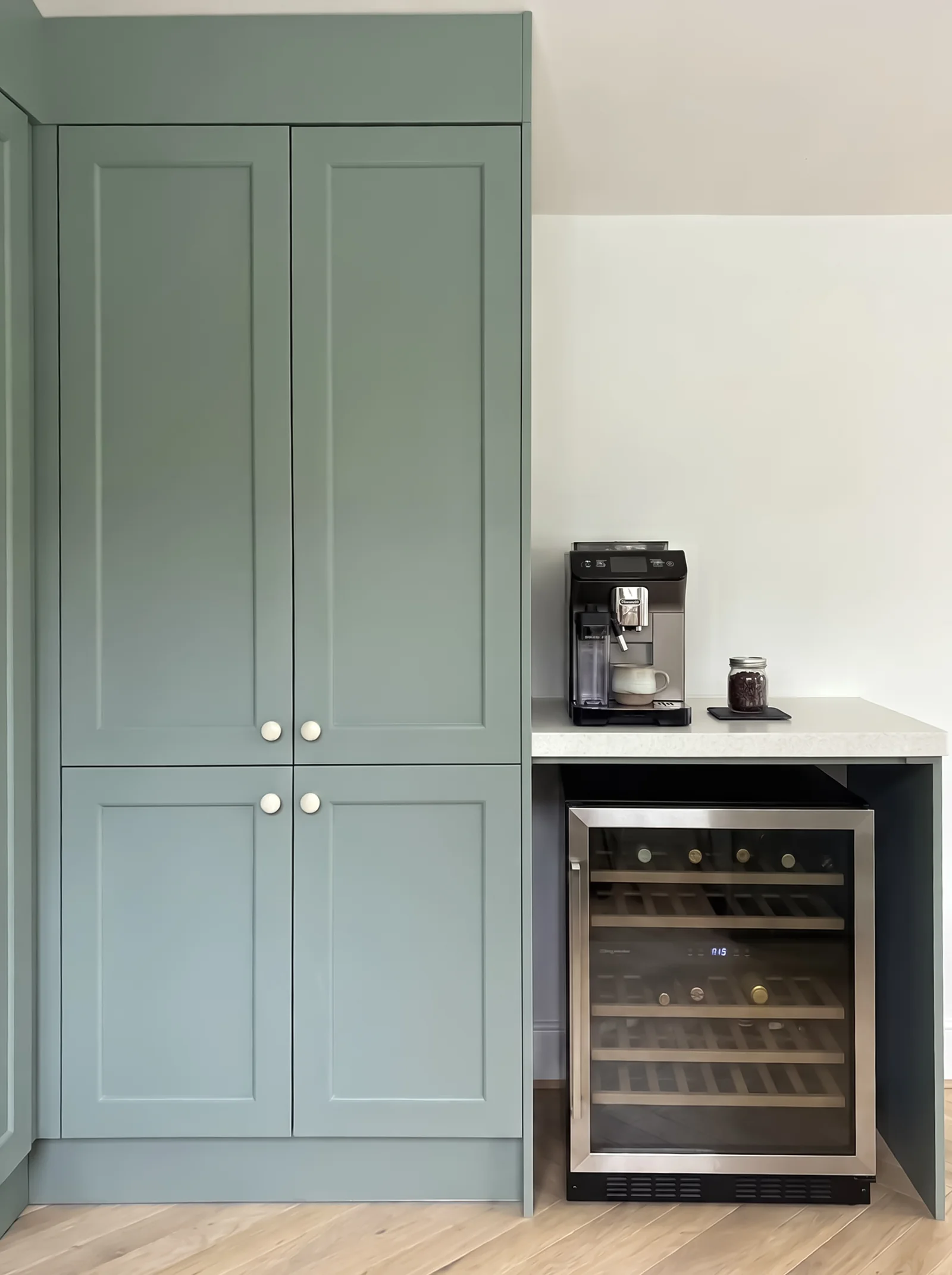 Sage shaker larder doors above a coffee machine and an under-counter wine fridge