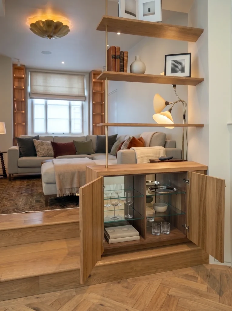 Open walnut cabinet revealing a storage interior beneath staggered floating oak shelves
